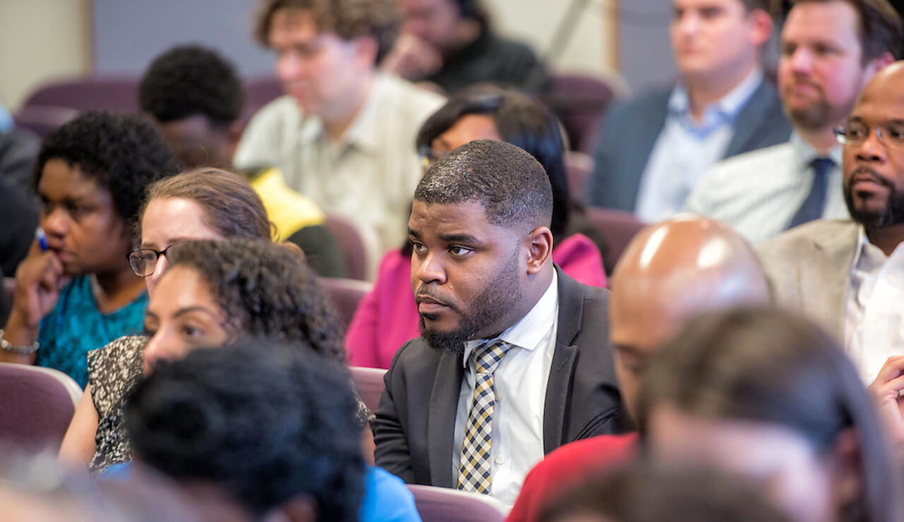 Audience sits in a training