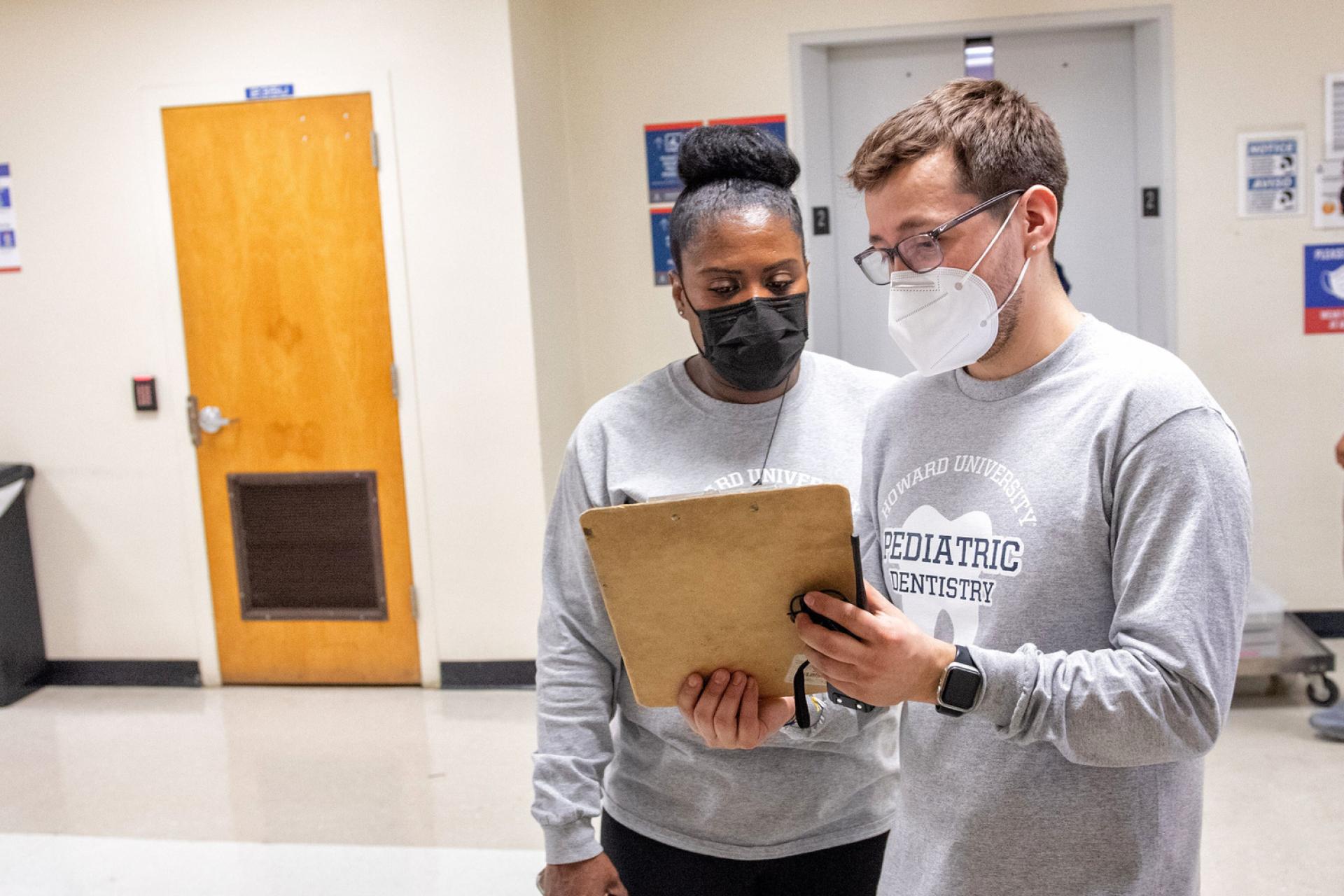 Dr. Barham and Dr. Garcia study xrays at Give Kids A Smile Day