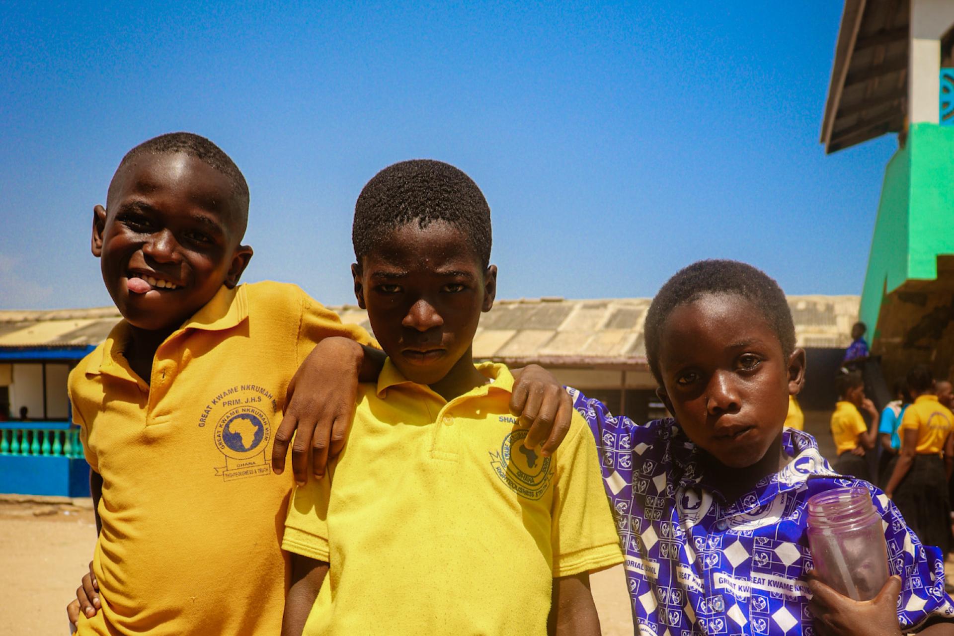 Three students of Kwame Nkrumah Memorial School eagerly pose together