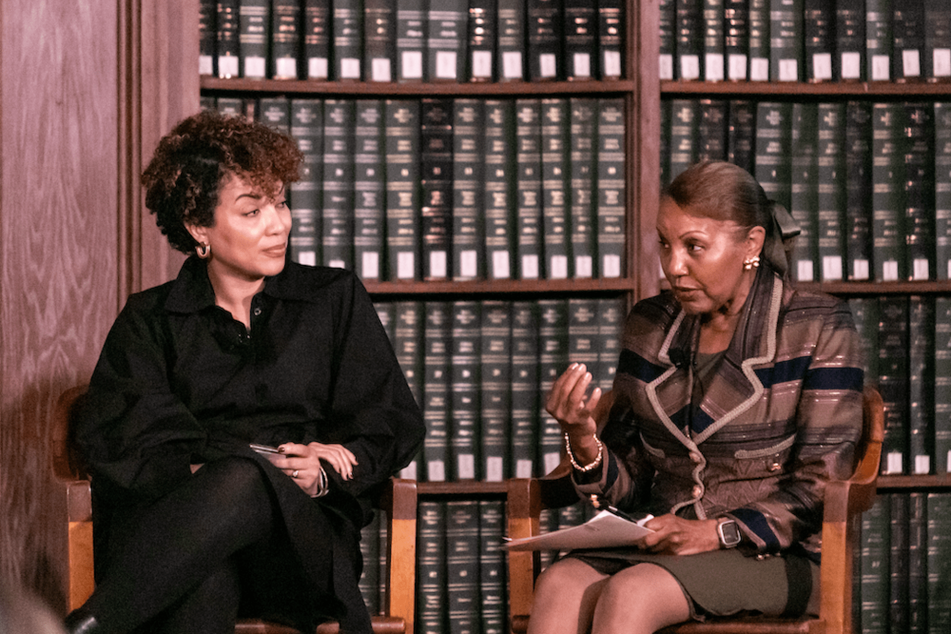 Dahlia Ndoum and Celia Maxwell sit on stage during the academic symposium during  inauguration week 2023