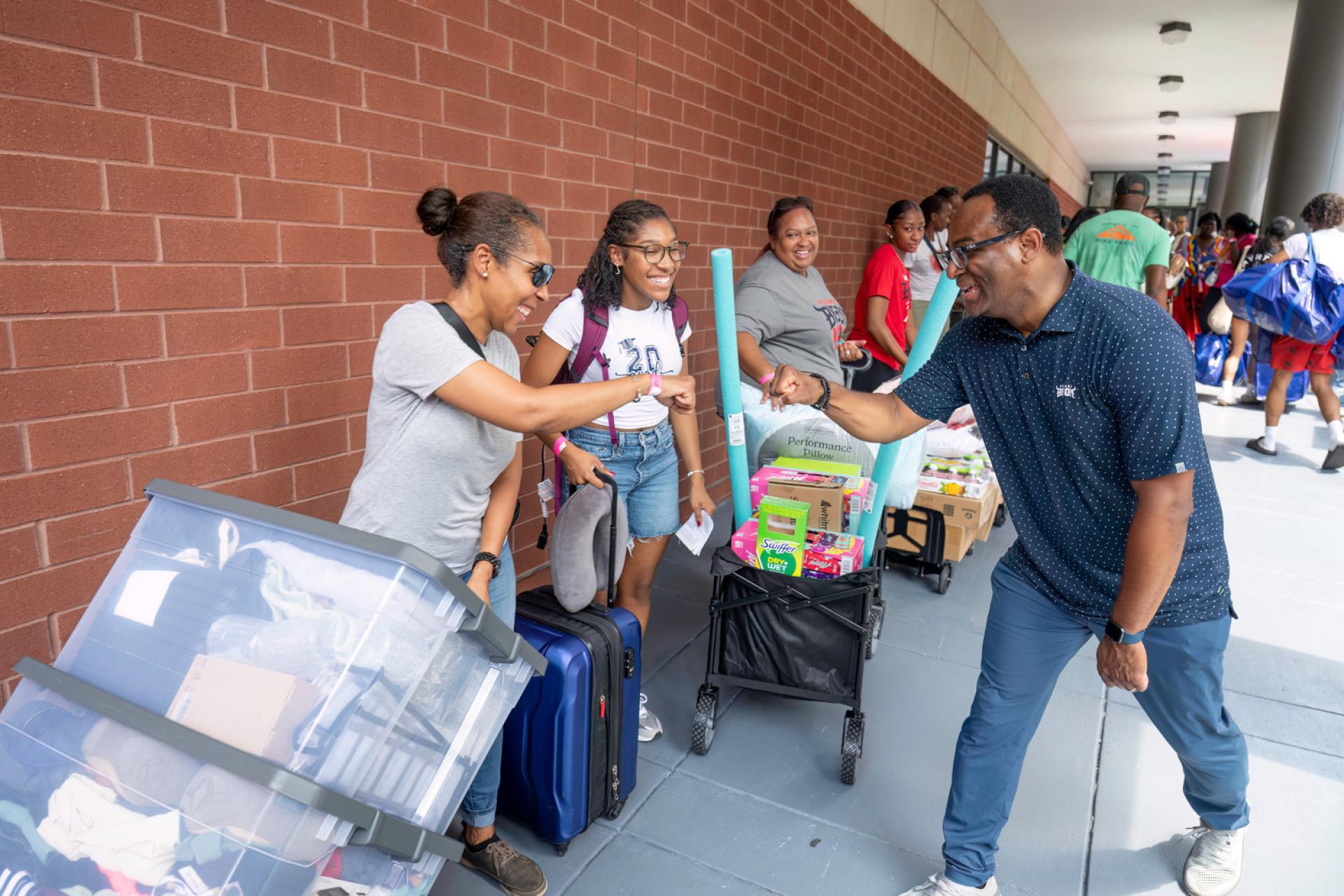 President Vinson does The Bison Bump with parents awaiting to move students in. (Photographer: Justin D. Knight)  