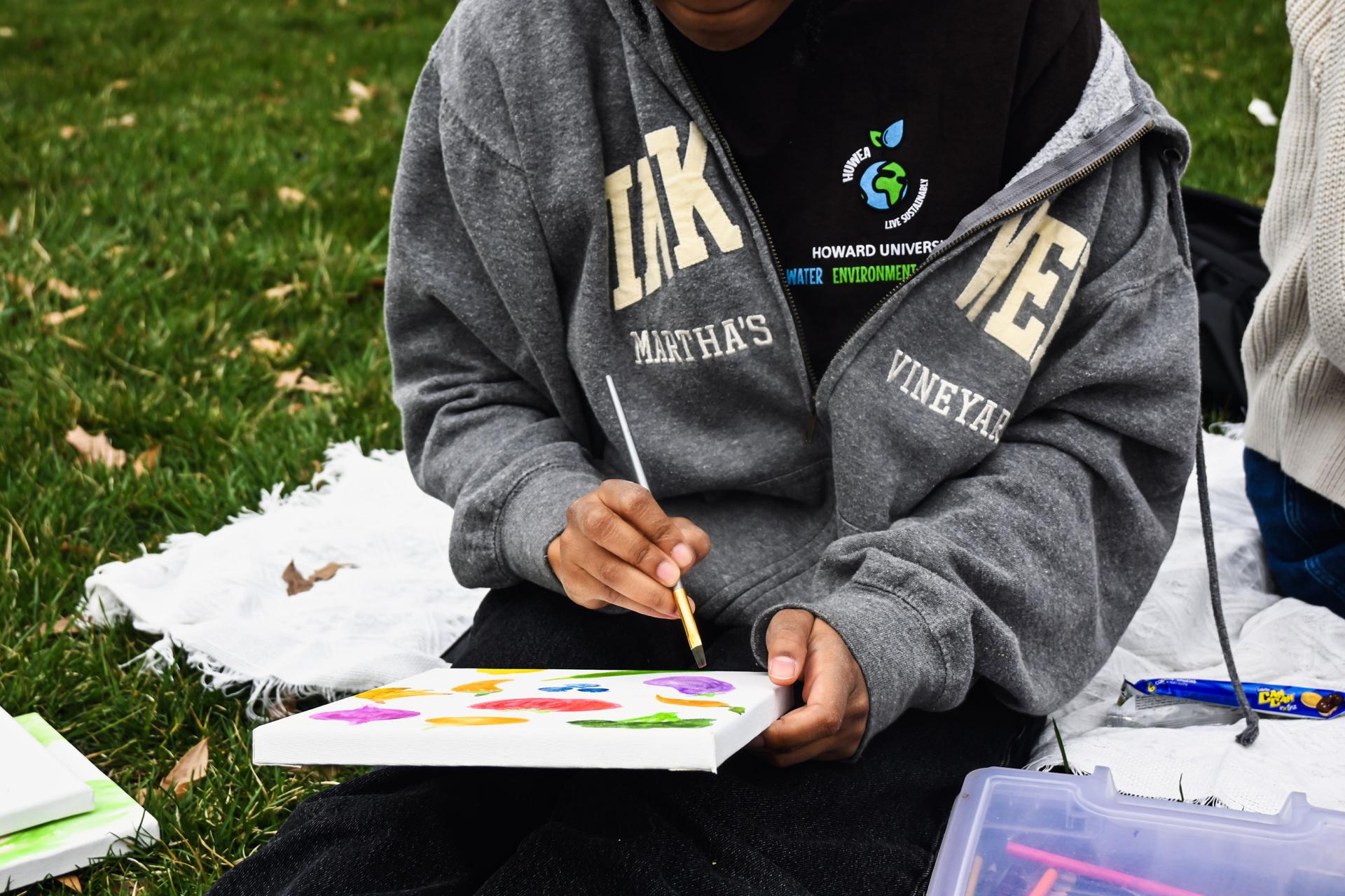 Student painting at Earth Day event 