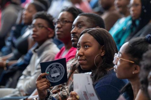 Student Holding a Howard University Sticker in Audience