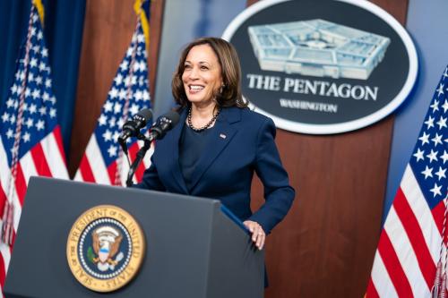 Kamala Harris at the Pentagon podium with American flags around her