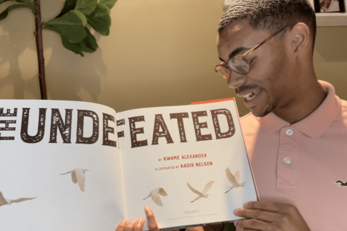 Tymek Jones reading picture book, The Undefeated