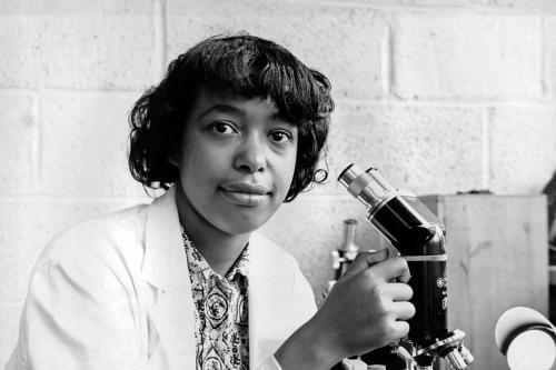Doctor, inventor, and advocate Patricia Bath with a microscope.