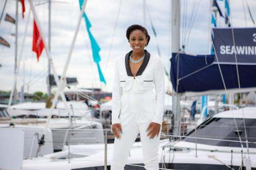 Sheila Ruffin standing on yacht in white suit