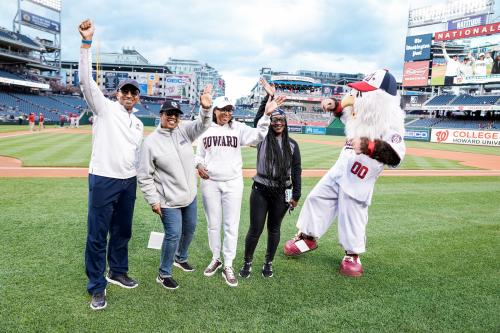 Howard University College of Nursing dean and others on Nationals Stadium field with mascots