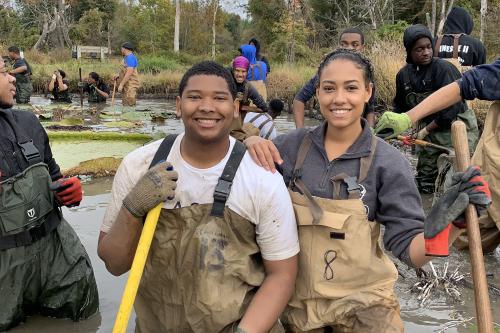 Student volunteers cleaning wetlands