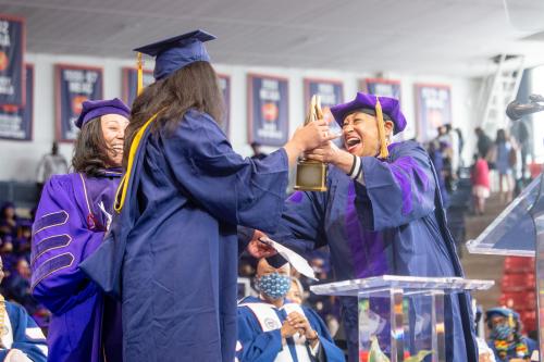 Margot Bouchet passes the torch to her granddaughter Dominique Jackson at commencement