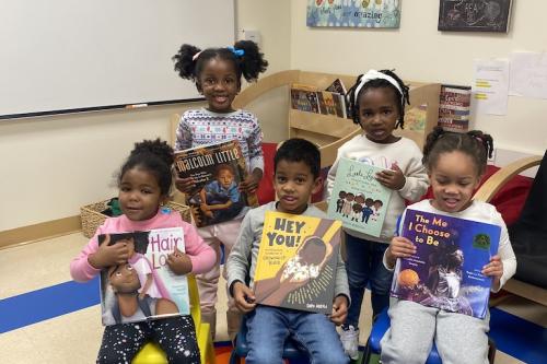 Children posing with books at Family Reading Night