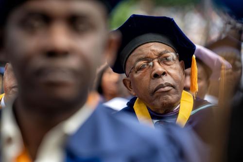 A golden class 50th anniversary graduate looks on during Howard University's commencement