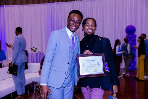 Darius Cooney and Joshua John-Louis, one of eight recipients of 2023 Howard University's Lavender Scholarship, pose together for their photos 