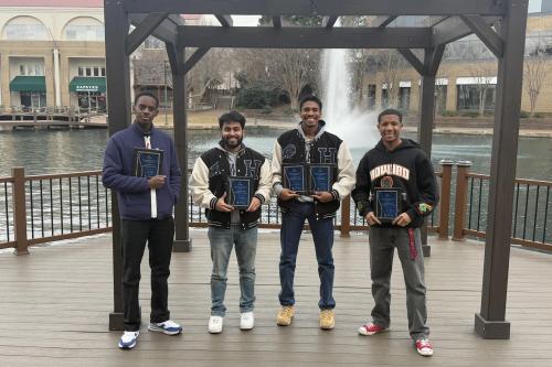 Howard University chess team pose with awards.