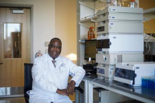 Akala seated in Howard University lab