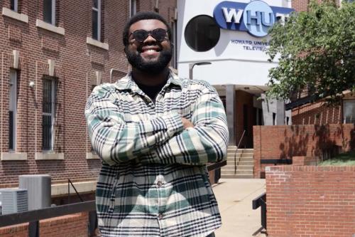 Folajinmi Awofeso standing in front of the WHUT-TV studio