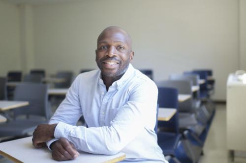 Brandon Hogan_philosophy professor, seated in a classroom