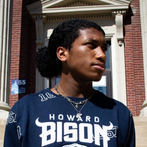 Kenzell Munroe in front of a Howard University building.
