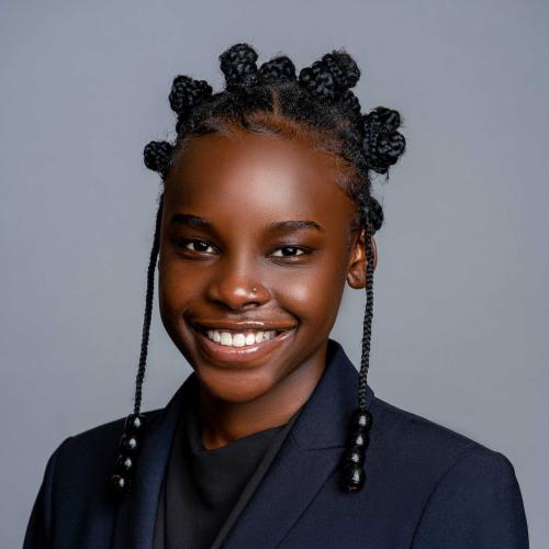 Nora Auma wearing a navy blue blazer and black blouse