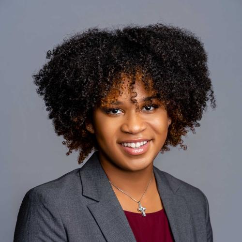 Autumn Edwards wearing a grey blazer with a maroon shirt