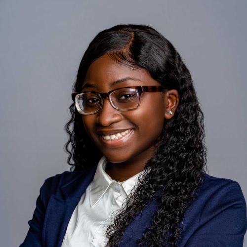 Diane Fakinlede wearing a royal blue blazer with a white button down shirt