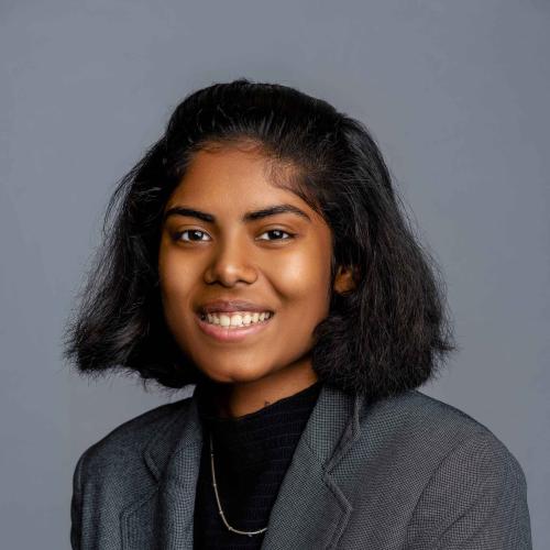 Ananya Hota wearing a grey blazer with a black shirt