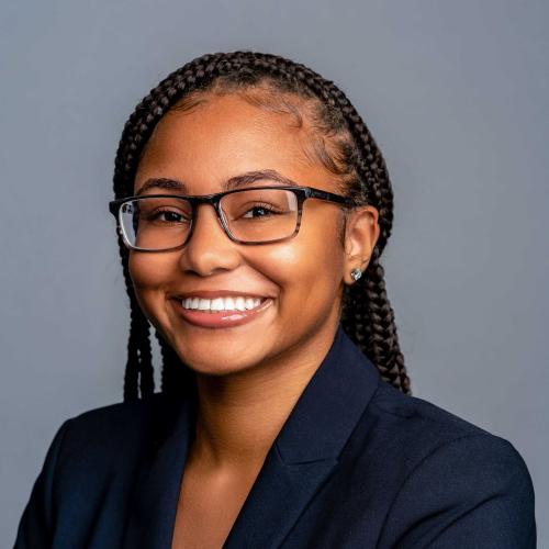 Salimah Thaxton wearing a navy blue blazer with a white blouse