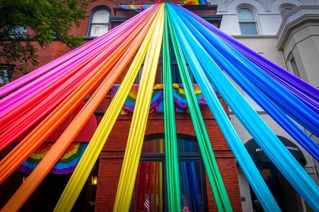 ribbons in rainbow order stretch up a DC townhouse