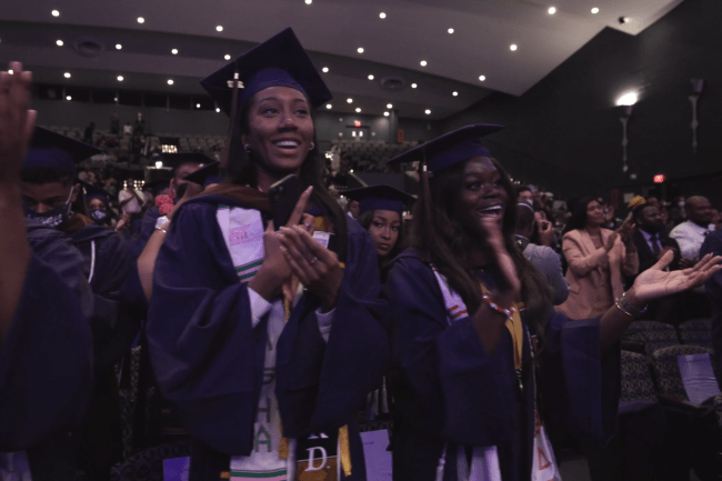 The crowd cheering at the inaugural graduation ceremony of Howard University's Chadwick Boseman School of Fine Arts