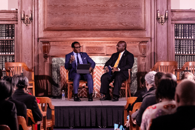 President Vinson and Provost Wutoh sit on stage at the academic symposium during inauguration week 2023