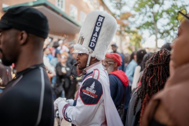 Howard Homecoming Drum Major stands in a crowd