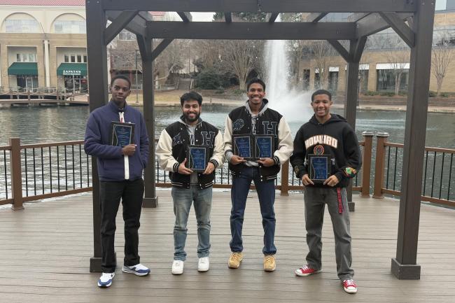 Howard University chess team pose with awards.
