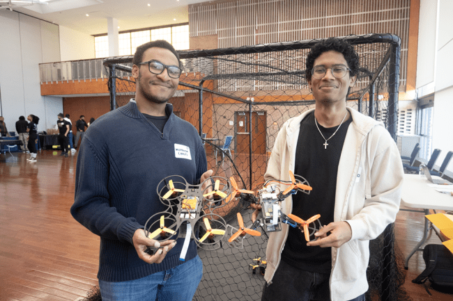 HURO Team Members Holding Drones at AI Event