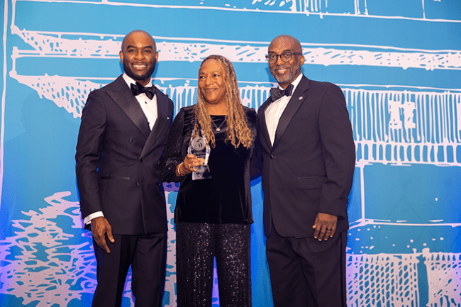 Sylvia Taylor accepting award from School of Business leadership