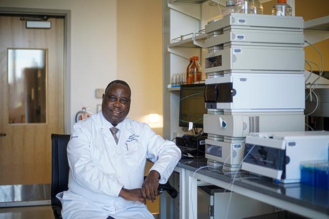 Akala seated in Howard University lab