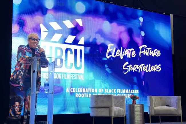 Shelia Eldridge on stage behind a clear podium