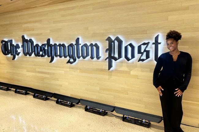 Zoe Cummings standing in front of the Washington Post sign