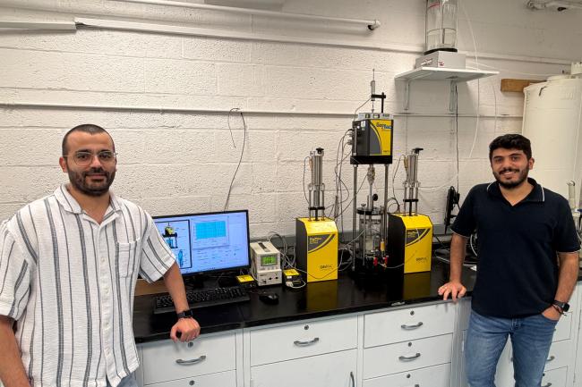 Jaradat at work in his Geomaterials Research Lab with Ph.D. student Mohammad Almasaeid