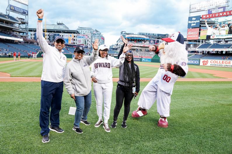Howard University College of Nursing dean and others on Nationals Stadium field with mascots