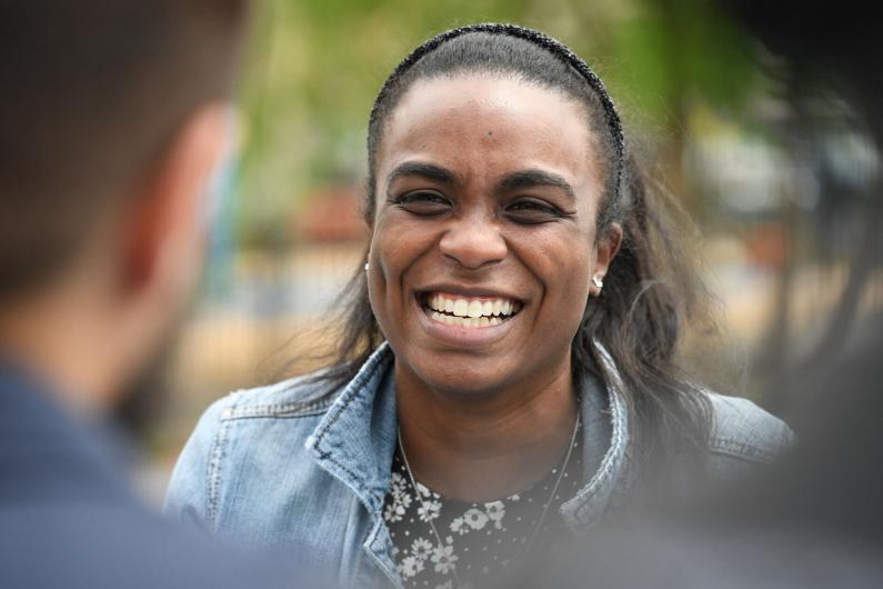 Black woman smiles in camera