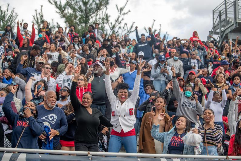 Howard Bison fans cheer during football game