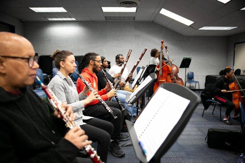HU Orchestra’s community players and students practice with their wind and string instruments for their upcoming spring concert.  