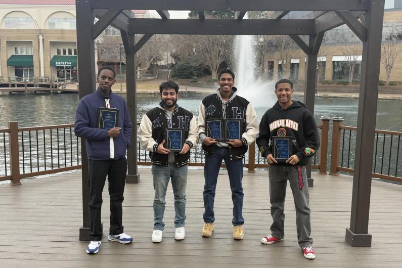 Howard University chess team pose with awards.