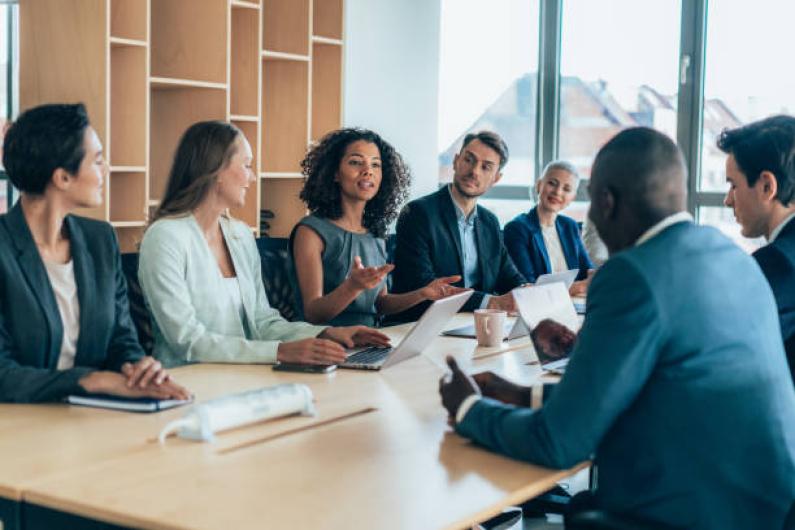 A diverse group of people hold a business meeting in a boardroom