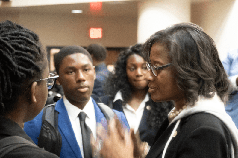 Dr. Hale speaking with students