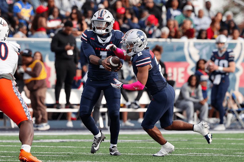 Howard football players on the field during homecoming game
