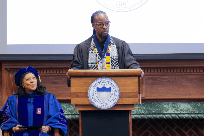 Dr. Ibram X. Kendi stands at a podium at Founder's Library at Howard University