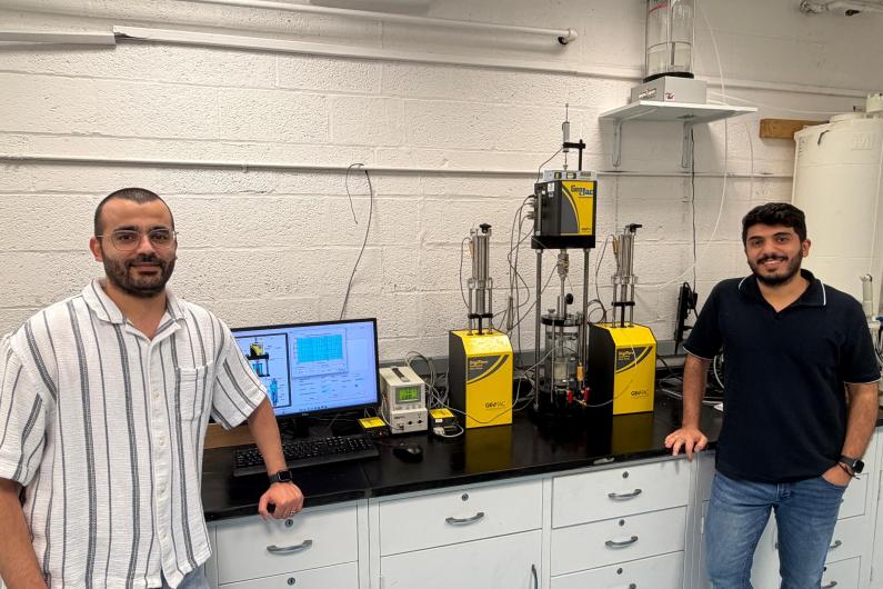 Jaradat at work in his Geomaterials Research Lab with Ph.D. student Mohammad Almasaeid