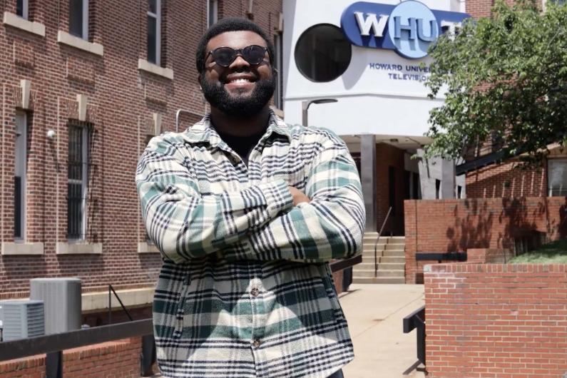 Folajinmi Awofeso standing in front of the WHUT-TV studio