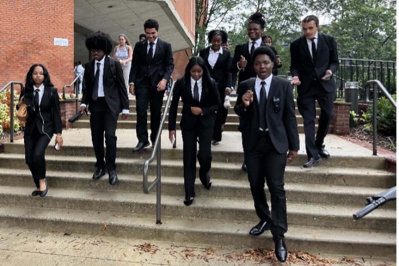 Students wearing black suits